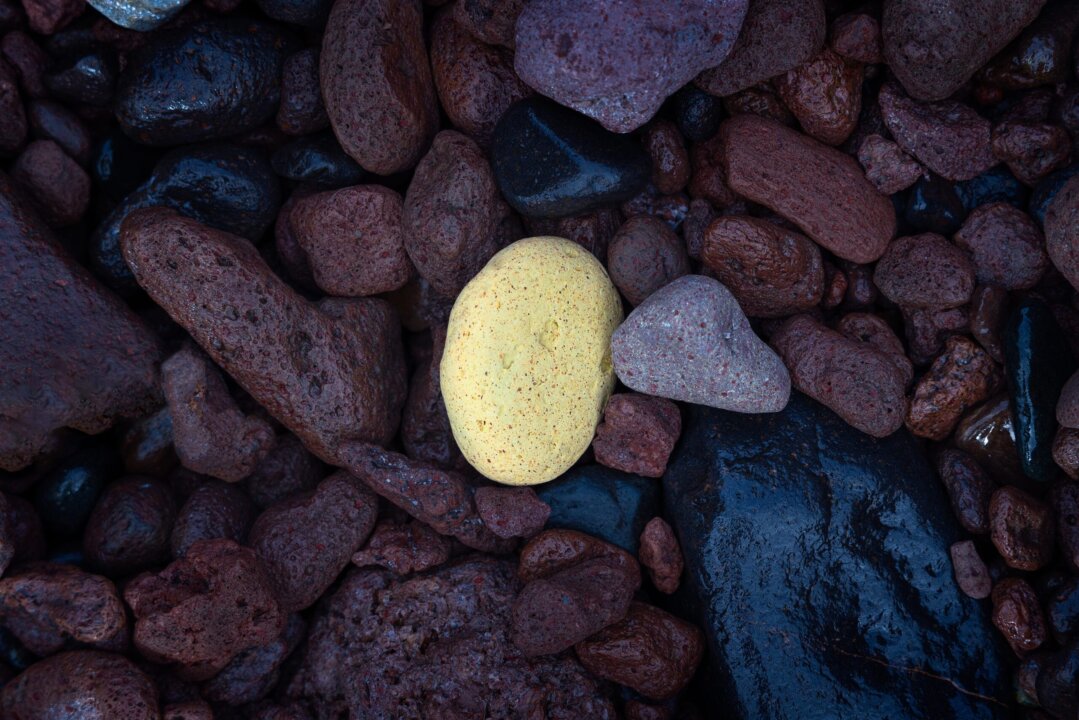 Close-up of red volcanic rocks with single pale stone, Gran Canaria