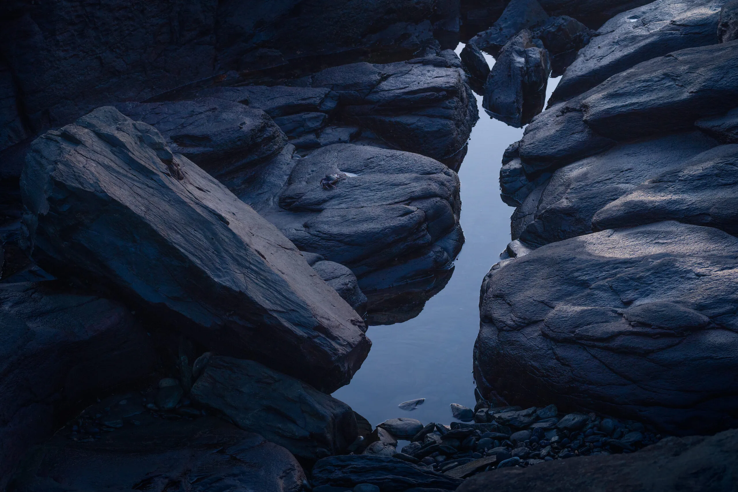 Dark volcanic rock pool with water reflection, Gran Canaria