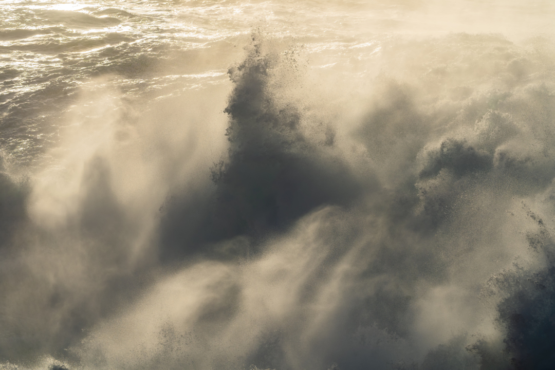 Soft golden ocean waves with warm amber light, long exposure