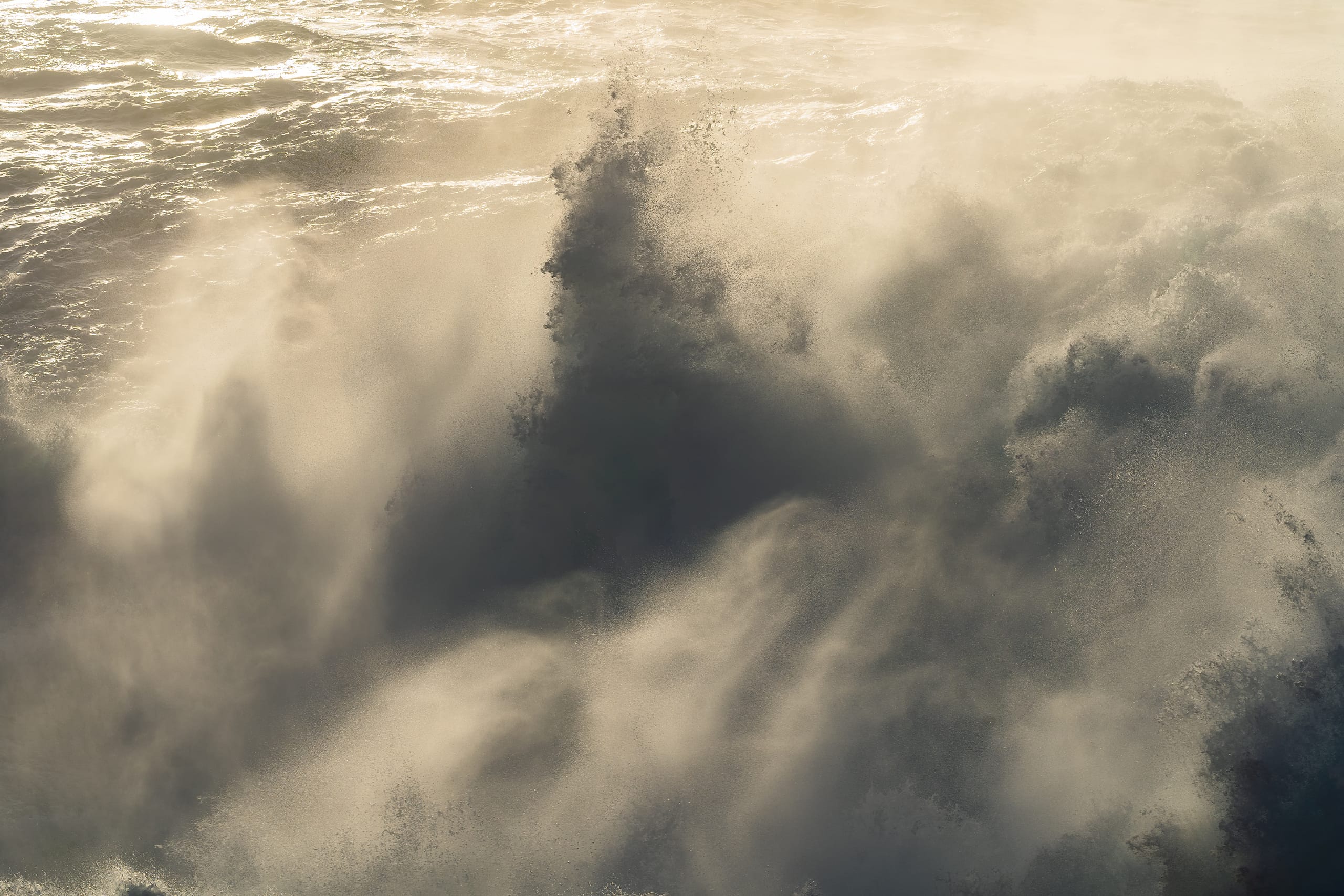 Soft golden ocean waves with warm amber light, long exposure