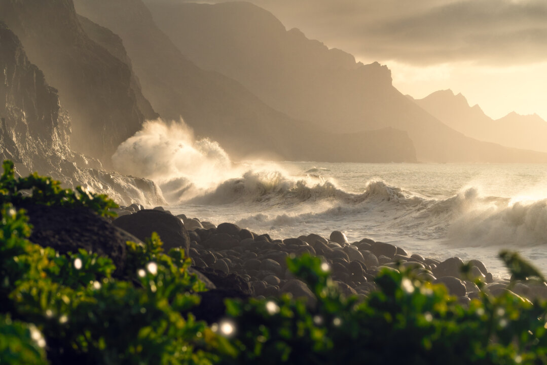Dramatic waves crashing on rocky coastline with misty cliffs, Guayedra Gran Canaria