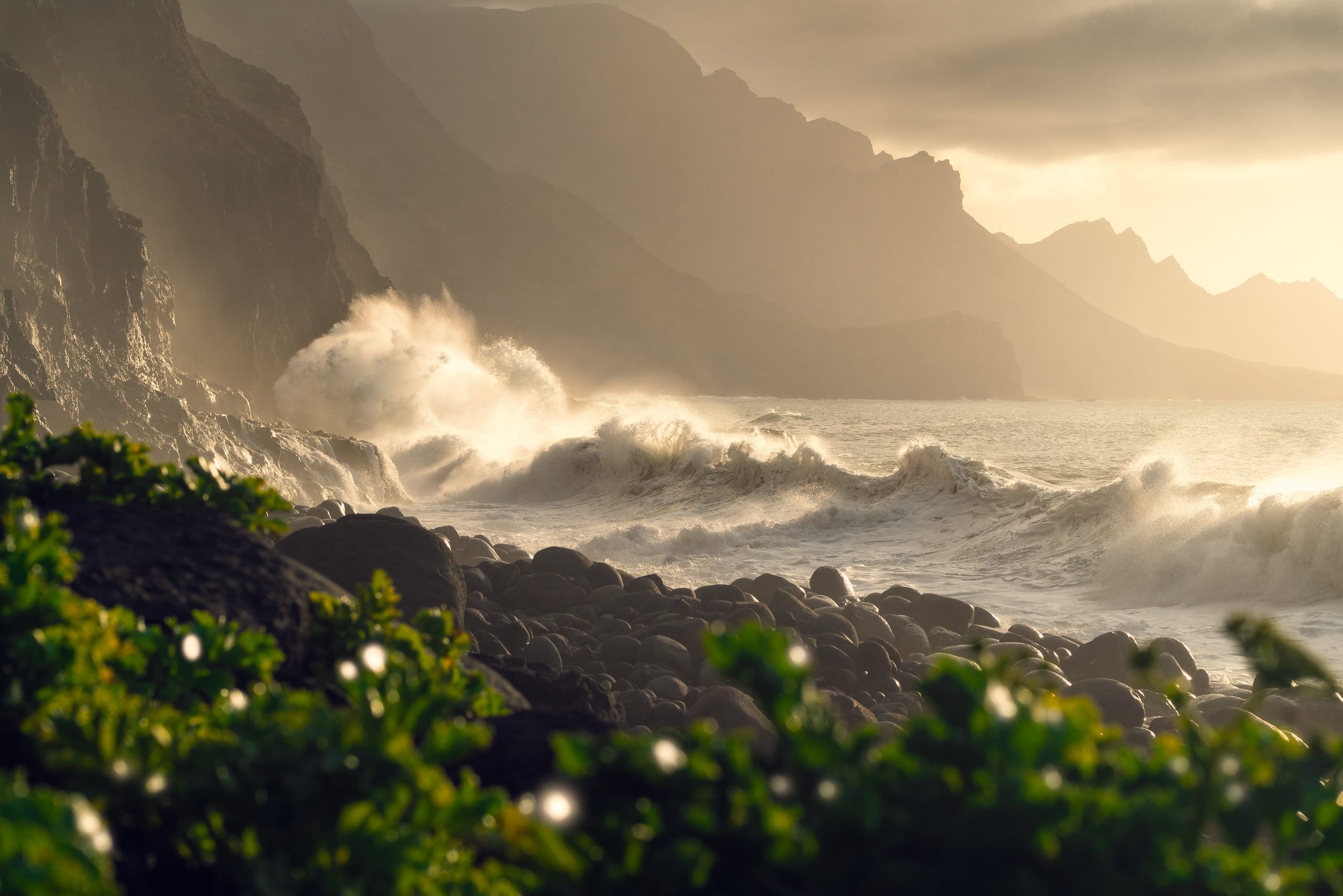 Dramatic waves crashing on rocky coastline with misty cliffs, Guayedra Gran Canaria