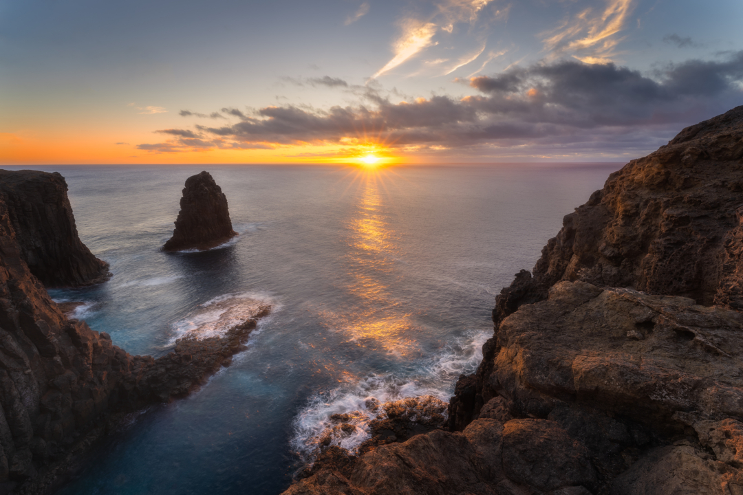 Sun setting over Atlantic ocean with volcanic sea stacks, Gran Canaria